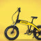 Compact electric folding bike in yellow, perfect for urban commuting with easy storage options.